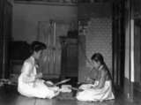 In Korea the drumming of traditional ironing sticks was traditionally considered a joyful sound, a symbol of a secure home life. Two women knelt on the floor, facing each other across a smoothing stone or tatumi-tol, a pangmangi club in each hand, beating out a rhythm on the cloth. A Korean tatumi-tol granite or marble block was a valued family possession, perhaps with carved decoration, especially on the underside, so the design was visible when it was stored upside down to protect the smooth top. Ironing with pangmangi clubs requires skillful co-ordination and partnership.