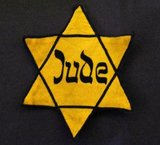 A Star of David, often yellow-colored, was used by the Nazis during the Holocaust as a method of identifying Jews. After the German invasion of Poland in 1939 there were initially different local decrees forcing Jews to wear a distinct sign – in the General Government e.g. a white armband with a blue Star of David on it, in the Warthegau a yellow badge in the form of a Star of David on the left side of the breast and on the back. If a Jew was found without wearing the star in public, they could be subjected to severe punishment. The requirement to wear the Star of David with the word Jude (German for Jew) inscribed was then extended to all Jews over the age of 6 in the Reich and the Protectorate of Bohemia and Moravia (by a decree issued on September 1, 1941 signed by Reinhard Heydrich) and was gradually introduced in other German-occupied areas.