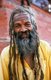 They are known, variously, as sadhus (saints, or 'good ones'), yogis (ascetic practitioners), fakirs (ascetic seeker after the Truth) and sannyasins (wandering mendicants and ascetics). They are the ascetic – and often eccentric – practitioners of an austere form of Hinduism. Sworn to cast off earthly desires, some choose to live as anchorites in the wilderness. Others are of a less retiring disposition, especially in the towns and temples of Nepal's Kathmandu Valley.<br/><br/>

If the Vale of Kathmandu seems to boast more than its share of sadhus and yogis, this is because of the number and importance of Hindu temples in the region. The most important temple of Vishnu in the valley is Changunarayan, and here the visitor will find many Vaishnavite ascetics. Likewise, the most important temple for followers of Shiva is the temple at Pashupatinath.
Vishnu, also known as Narayan, can be identified by his four arms holding a sanka (sea shell), a chakra (round weapon), a gada (stick-like weapon) and a padma (lotus flower). The best-known incarnation of Vishnu is Krishna, and his animal is the mythical Garuda.<br/><br/>

Shiva is often represented by the lingam, or phallus, as a symbol of his creative side. His animal is the bull, Nandi, and his weapon is the trisul, or trident. According to Hindu mythology Shiva is supposed to live in the Himalayas and wears a garland of snakes. He is also said to smoke a lot of bhang, or hashish.